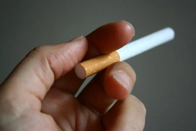 A person holding a cigarette in their hand.