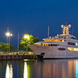 A large white boat docked at the dock.