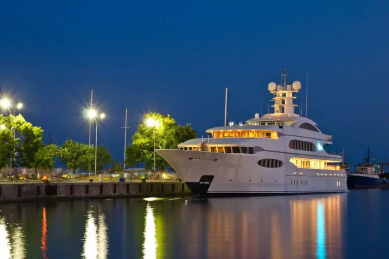 A large white boat docked at the dock.