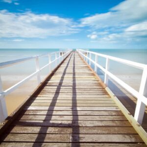 A boardwalk that is going over the water.