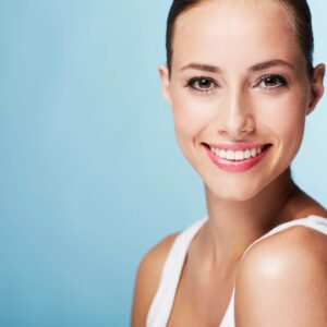 A woman with white teeth smiling for the camera.