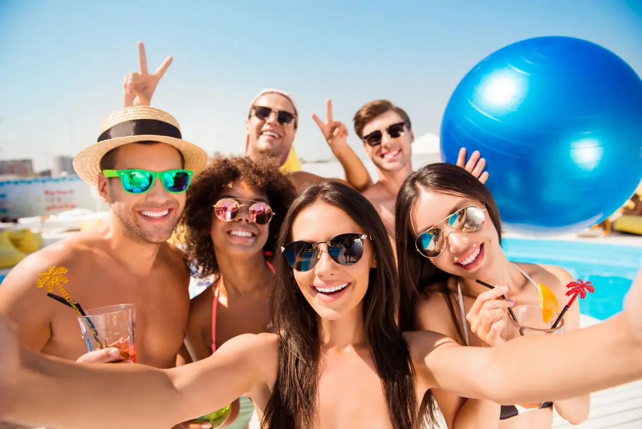 A group of people taking a selfie at the beach