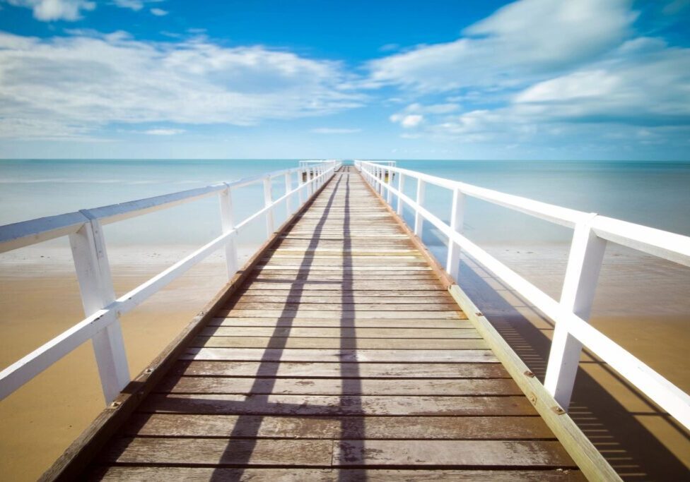 A boardwalk that is going over the water.