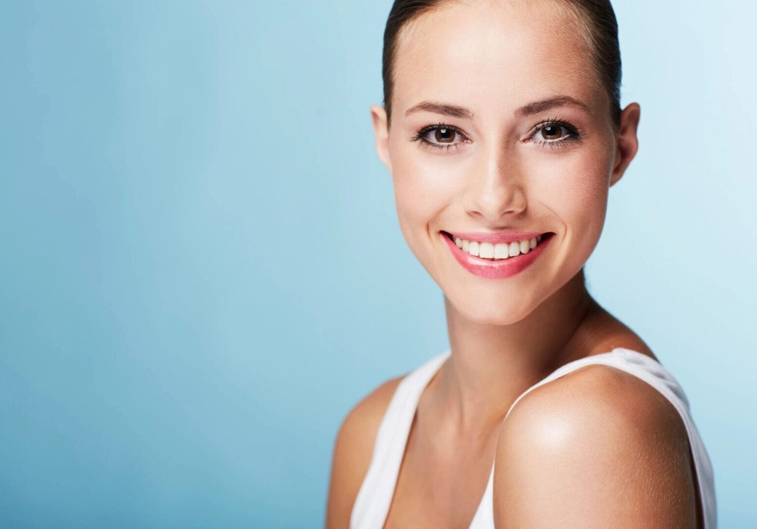 A woman with white teeth smiling for the camera.