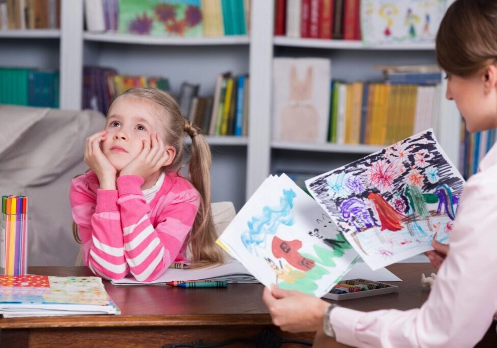 A girl sitting at the table with her mother.