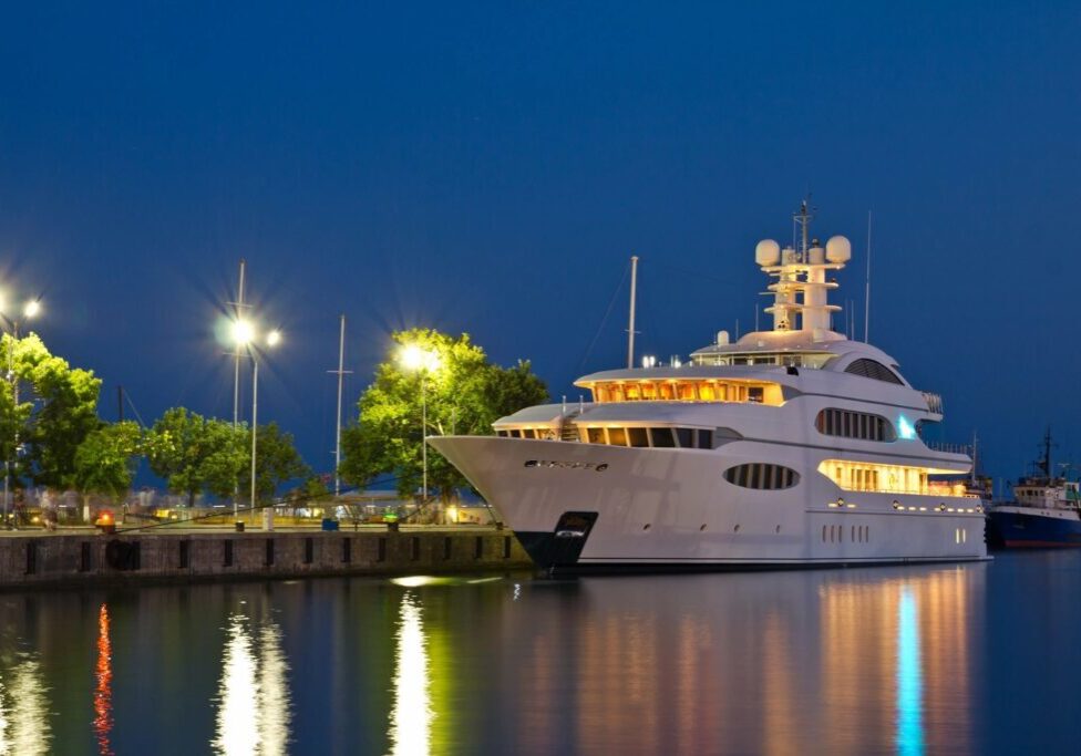 A large white boat docked at the dock.