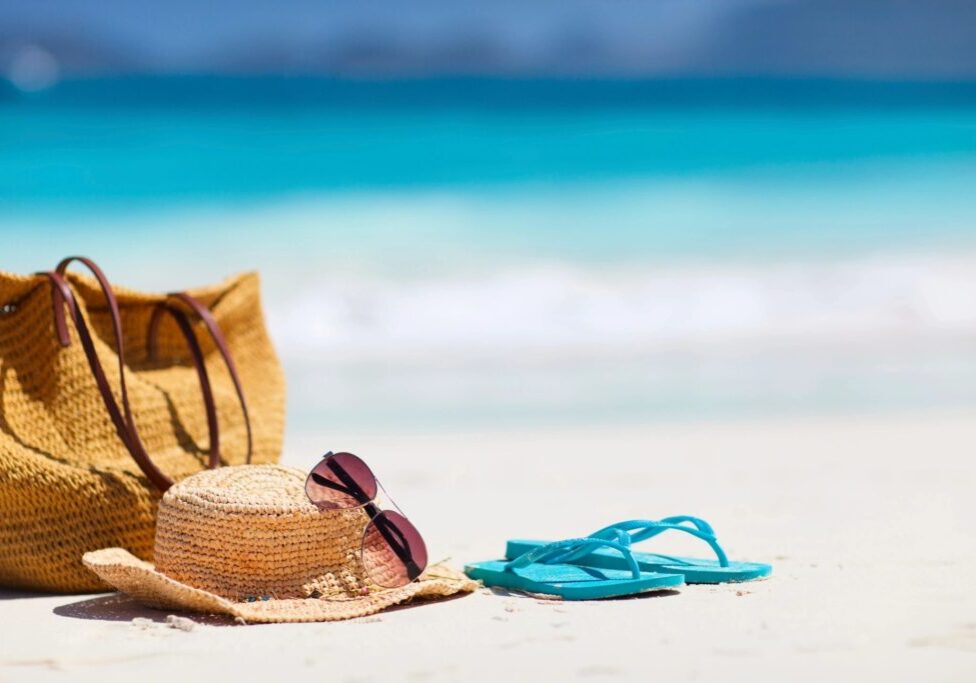 A straw hat and sunglasses on the beach