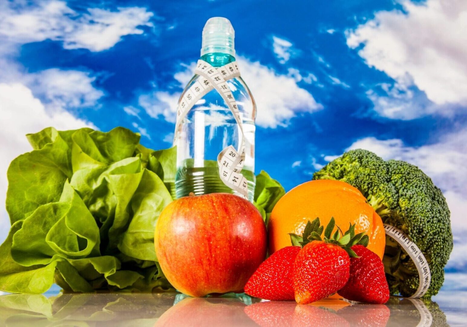 A bottle of water and some fruits on the table